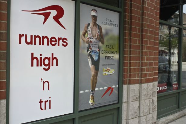 Runners High 'n Tri Arlington Heights.  Add a solid white background to simple lettering to make it stand out even more and also to cover up storage rooms or the back of shelving.  